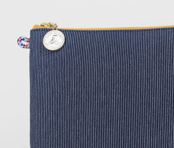 Miss Zip; cosmetic pouch; cosmetic; cosmetic bag; water repllent; denim; zipper pouch; wristlet; clutch; clutch purse; made in usa; blue; purse; stitch;