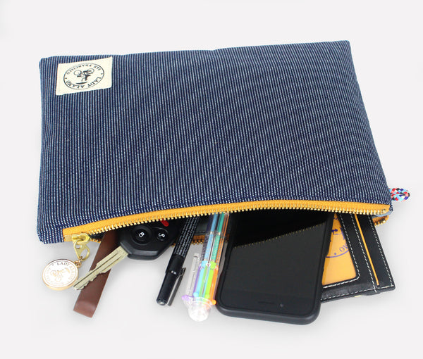 Miss Zip; cosmetic pouch; cosmetic; cosmetic bag; water repllent; denim; zipper pouch; wristlet; clutch; clutch purse; made in usa; blue; purse; stitch;
