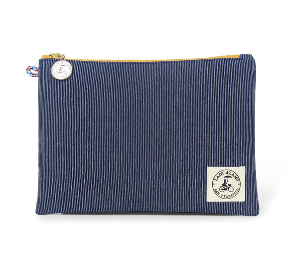 Miss Zip; cosmetic pouch; cosmetic; cosmetic bag; water repllent; denim; zipper pouch; wristlet; clutch; clutch purse; made in usa; blue; purse; stitch;